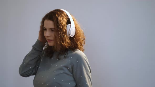 Attractive Girl with Curly Hair Relaxing Listening the Music alt