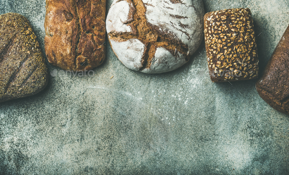 Top view of bread loaves over grey background, copy space - Stock Photo - Images