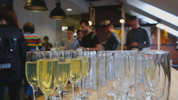 Glasses with Champagne in the Foreground, Blurred People on the Background