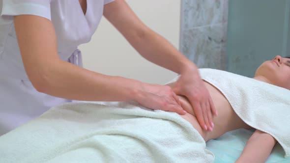 Masseur Doing Anti Cellulite Massage on Woman Abdomen in Beauty Salon alt