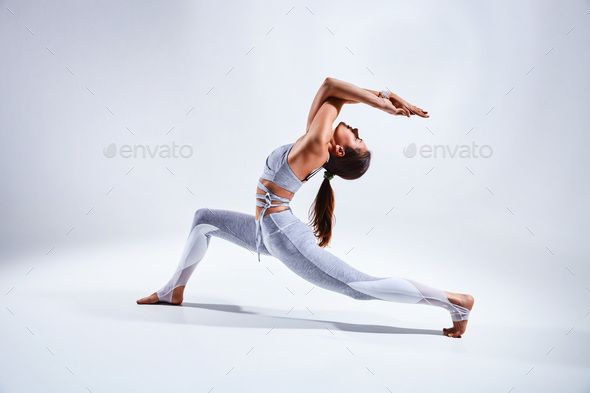 Woman doing yoga isolated on white background - Stock Photo - Images