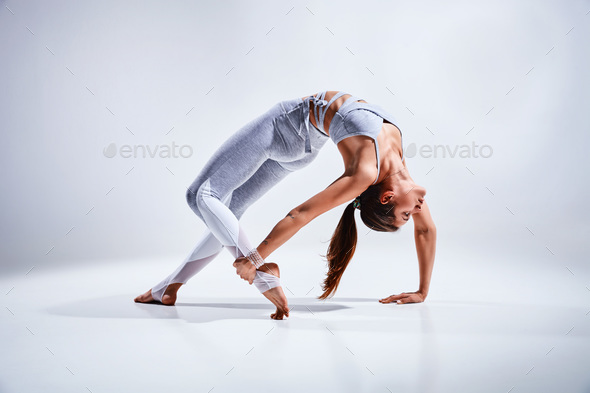 Woman doing yoga isolated on white background - Stock Photo - Images