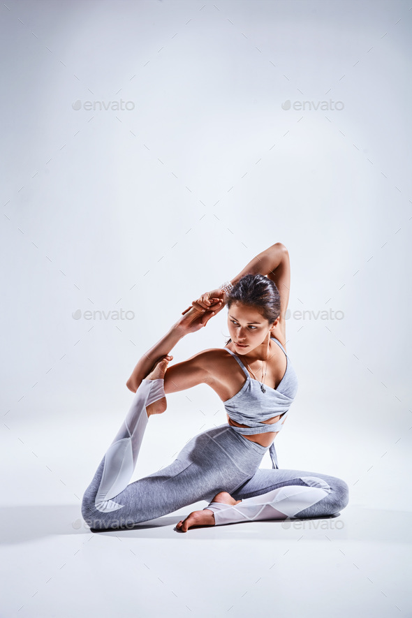 Woman doing yoga isolated on white background - Stock Photo - Images