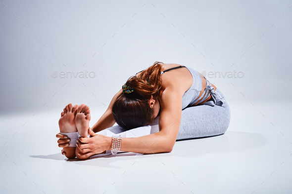 Woman doing yoga isolated on white background - Stock Photo - Images