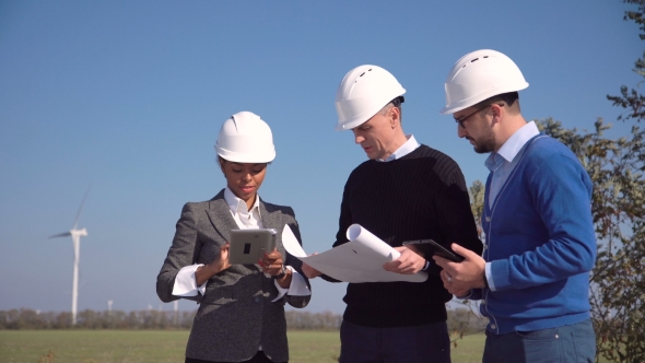 Three Engineers Standing in Open Field alt