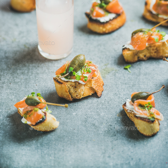 Crostini with smoked salmon and grapefruit cocktails, square crop - Stock Photo - Images