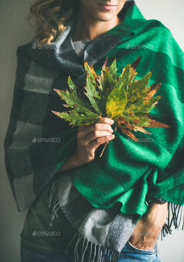 Woman in scarf or blanket and jeans with Autumn leaves - Stock Photo - Images