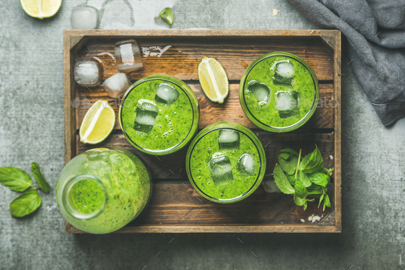 Fresh green smoothie with ice cubes, mint, lime in tray - Stock Photo - Images