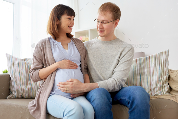 happy pregnant wife with husband at home
