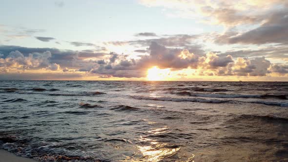 panorama of the sun setting over the sea. Sunset with beautiful clouds.