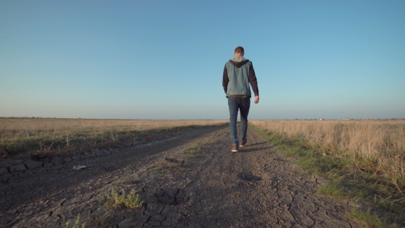 Young Man Walking Away Down a Rural Road, Stock Footage | VideoHive
