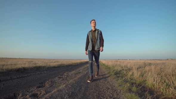 Young Man Walking Away Down a Rural Road, Stock Footage | VideoHive