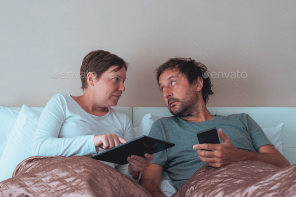 Serious couple, husband and wife in bedroom