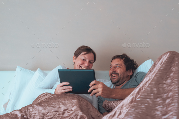 Happy couple, husband and wife in bedroom
