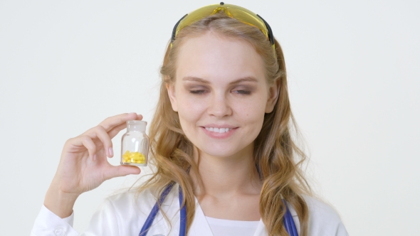 Young Smiling Doctor with Jar of Capsules Friendly Female Doctor