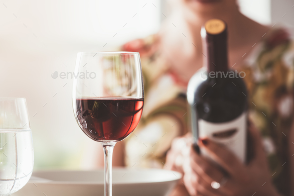 Woman reading a wine label