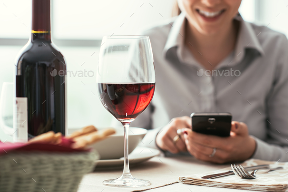 Woman using a smartphone at the restaurant