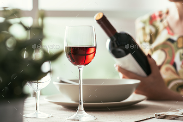 Woman reading a wine label