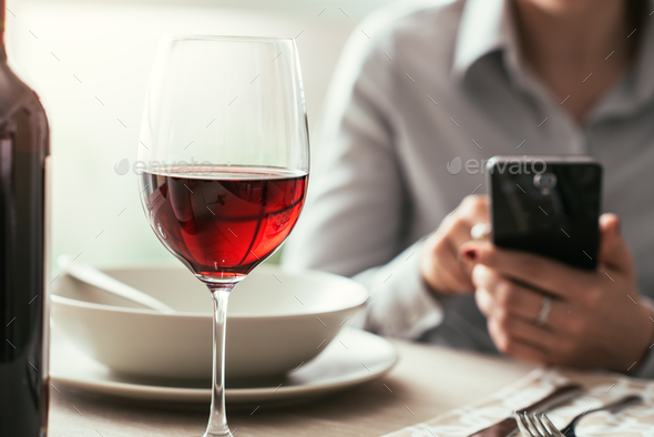Woman using a smartphone at the restaurant