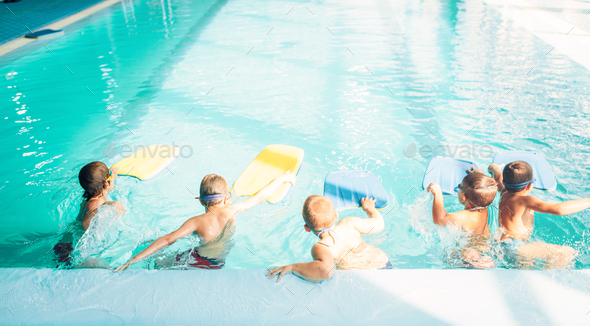 Boys starts simming in pool with plank - Stock Photo - Images
