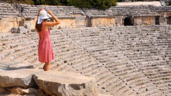 Pretty Woman Watching the Ruins of Antique Theater alt