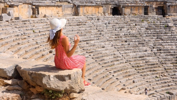 Pretty Woman Watching the Ruins of Antique Theater alt