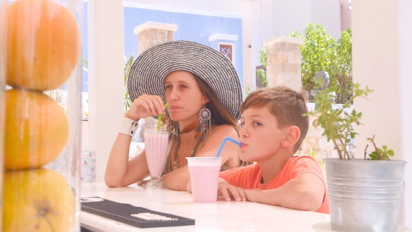 The Boy and His Mother Sit at a Bar alt