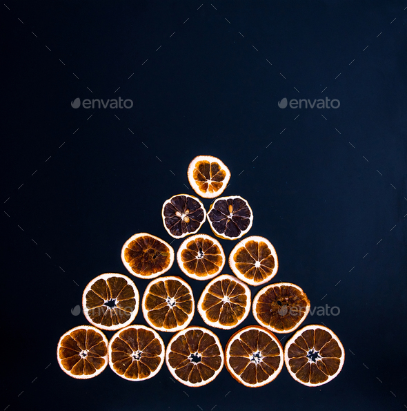Christmas tree made from dried orange slices on black background