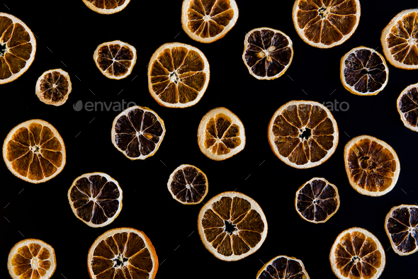Creative image of dried orange slices on black background