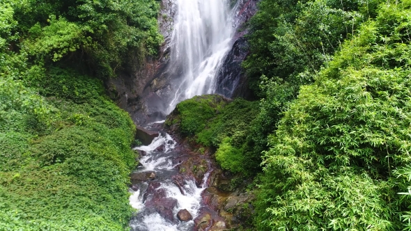 Aerial View in Motion of the Waterfall Flows Down the Stony Slope on Adam's Peak in Sri Lanka