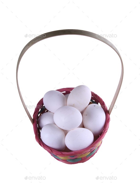 Eggs in a straw basket isolated