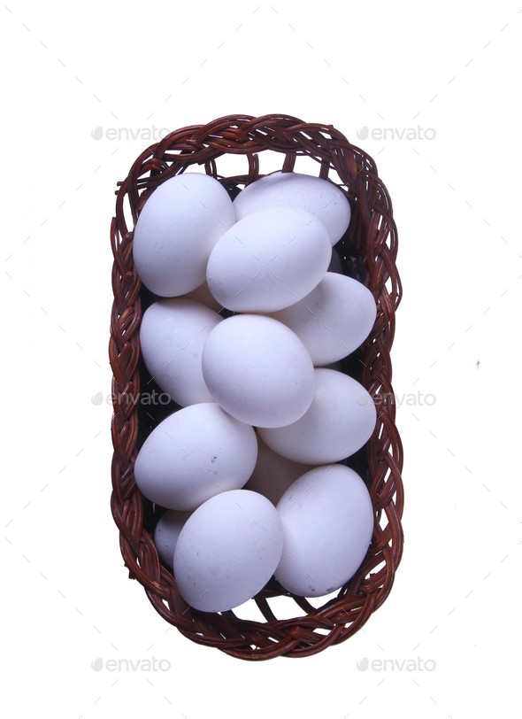 Eggs in a straw basket top view isolated