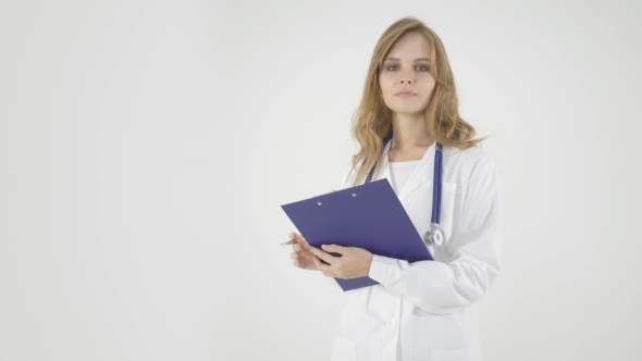 Beautiful Female Doctor Holding Clipboard and Smiling on White Background.