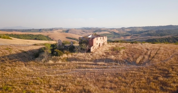 Ruined Building in Sunlit Fields alt