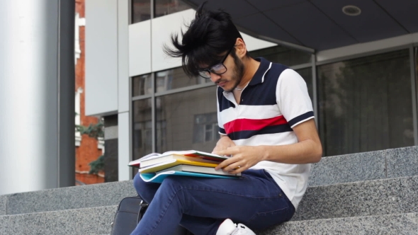 Asian Student Man Sitting on Stairs and Reading Books