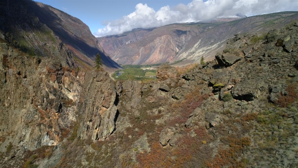 Aerial Footage. Flying Over a Mountain Ridge and Valley. Rocky Terrain. Cliff