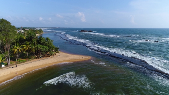 Aerival View in Motion Sea Sandy Beach and Light Waves at the Resort in Sri Lanka