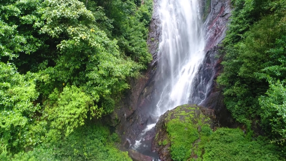 Aerial View in Motion of the Water Flows Down the Rocky Mountain in Adam's Peak in Sri Lanka