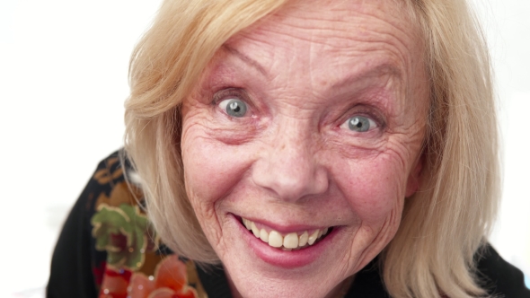 Happy smiling old woman gazing steadily