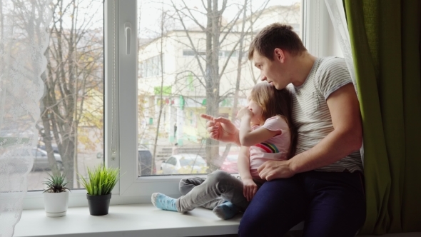 Father Shows Something To a Daughter alt