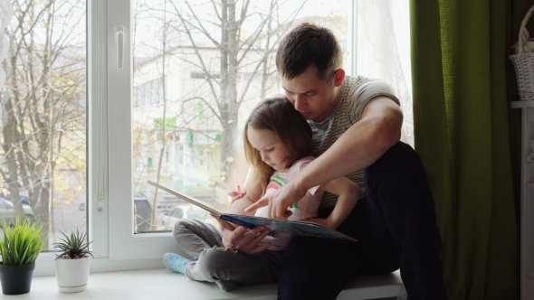 Father and Daughter Reading a Book