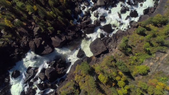 Aerial Flight Over Steam Raging River and Waterfall in Autumn Forest