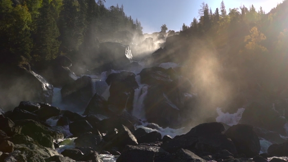 Footage of a Rocky Waterfall in a Backlight.