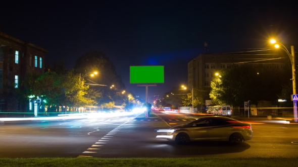 A Billboard with a Green Screen on a Background of City Traffic with Long Exposure