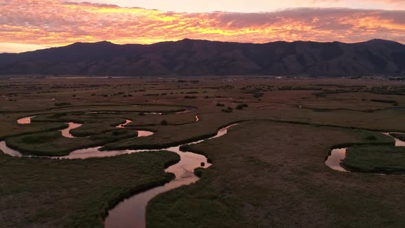 Rotating aerial view of river winding through Star Valley Wyoming alt