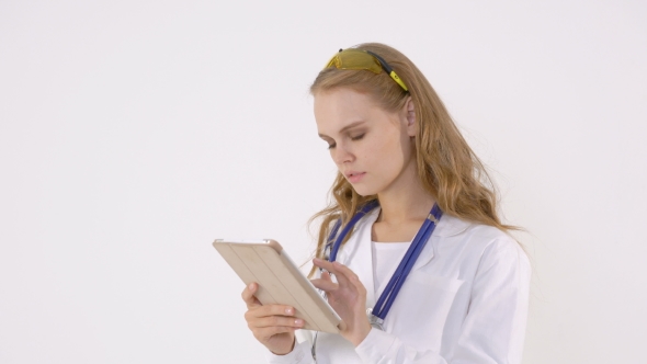 Happy Female Doctor Using Tablet Computer on a White Background