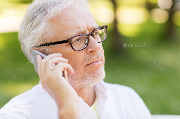 sad senior man in glasses calling on smartphone
