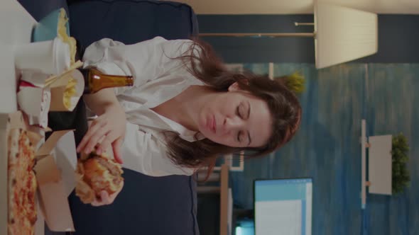 Vertical Video Person Eating Delicious Hamburger and Fries in Living Room alt