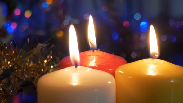 New Year's Candles, and Christmas Decorations Blurred Background with Colored Lights. Movement of