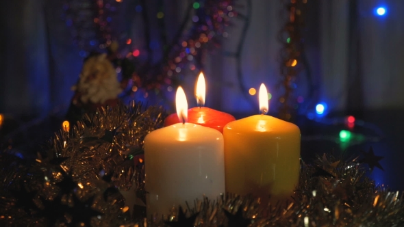 New Year's Candles, and Christmas Decorations Blurred Background with Colored Lights